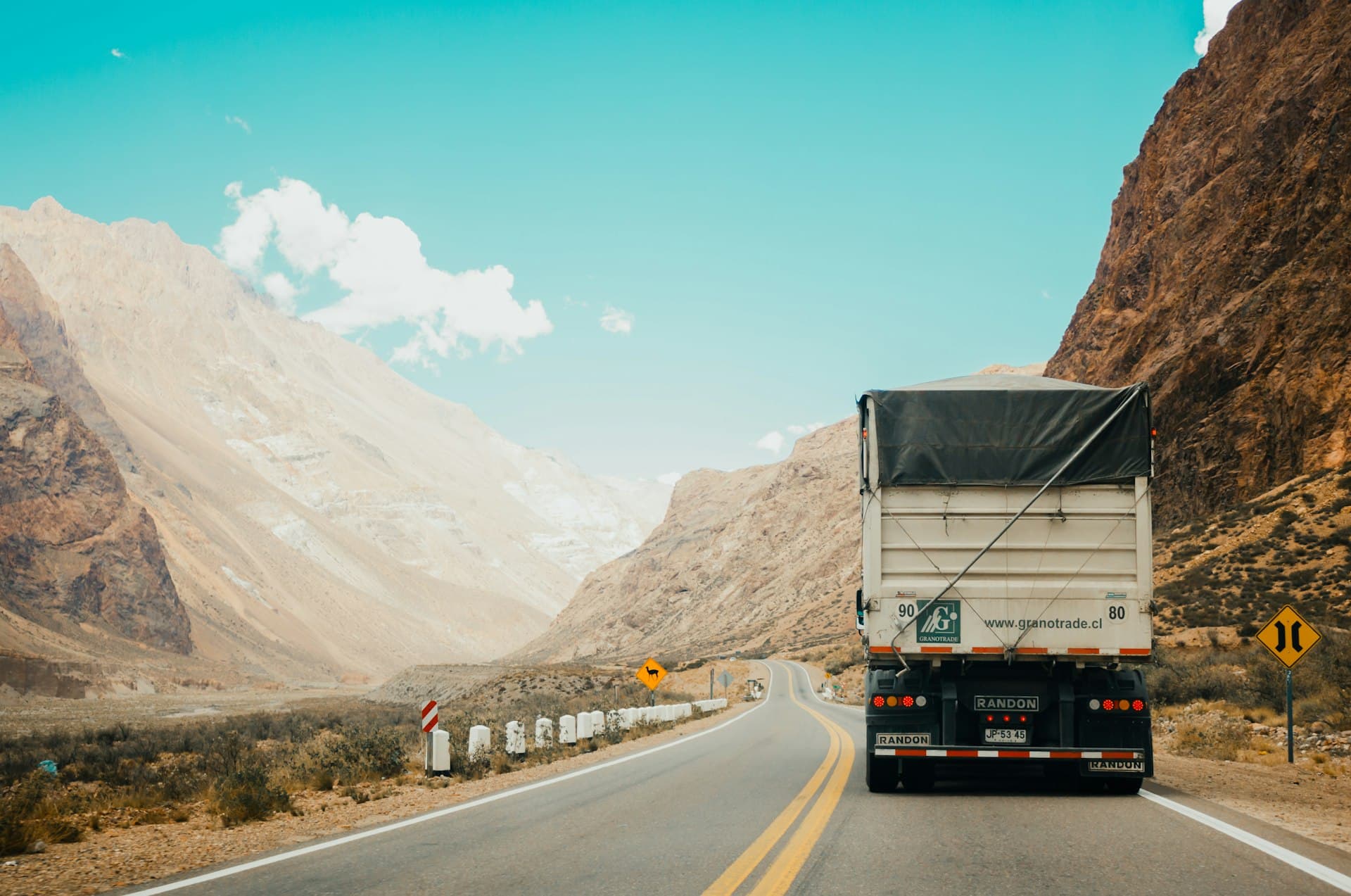 Semi truck on the open highway at sunset